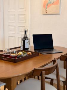 a laptop computer sitting on a table with a tray of food at sinae stayG in Seoul