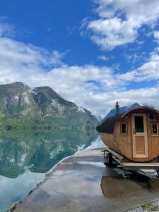 a house sitting on top of a body of water at Minihouse Stryn in Oppstryn