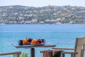 a tray of fruit on a table near the water at Alidian bay Suites Leros in Alinda +46 photos