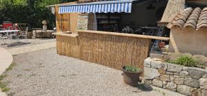 a fence in front of a building with a restaurant at comfortable studio in Grasse
