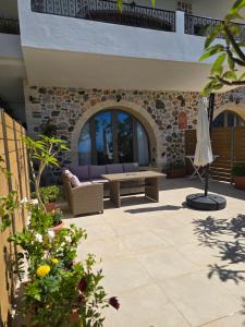 a patio with a couch and a table at Wind Apartment in Agia Roumeli in Agia Roumeli