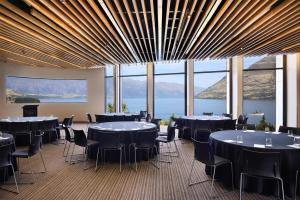 a conference room with tables and chairs and a large window at Rendezvous Heritage Hotel Queenstown in Queenstown +84 photos