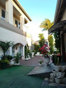 a courtyard with potted plants and a building at The Rest Place B&B in East London