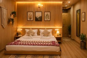 a bedroom with a large bed and wooden walls at KOKILARIVERSONGHomesaty in Banjār