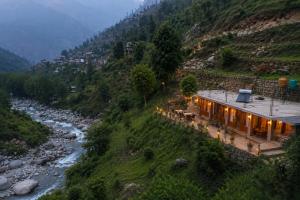 a house on a hill next to a river at KOKILARIVERSONGHomesaty in Banjār
