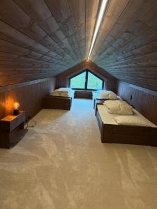 a large room with two beds and a window at Stor hytte på Gaustablikk in Gaustablikk