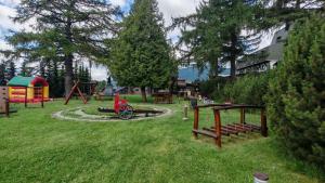 a park with a playground and a play area at Apartmán EveRest Donovaly in Donovaly