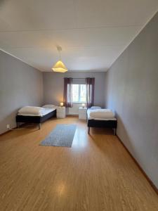 a large room with two beds and a window at Livning Horndal in Horndal