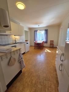 an empty kitchen and dining room with a table at Livning Horndal in Horndal
