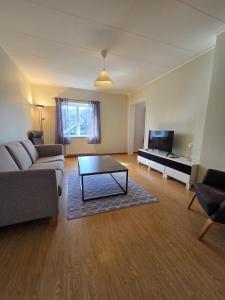 a living room with a couch and a coffee table at Livning Horndal in Horndal