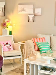 a living room with a couch and a table at Fleur de Ré in Loix
