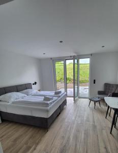 a bedroom with a bed and a couch and a table at Hotel Elb Blick in Jork