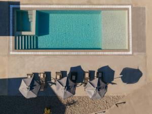 an overhead view of chairs and umbrellas next to a pool at Villa Samantha - Private Pool, 3 Ensuite Bedrooms & Complete Privacy near Laganas, By TK Premium Stays in Ambelókipoi