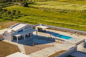 an overhead view of a house with a swimming pool at Villa Samantha - Private Pool, 3 Ensuite Bedrooms & Complete Privacy near Laganas, By TK Premium Stays in Ambelókipoi