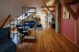 a living room with a spiral staircase in a house at Amber Private Rooms in Riga