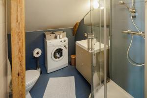 a bathroom with a toilet and a washing machine at Amber Private Rooms in Riga +103 photos