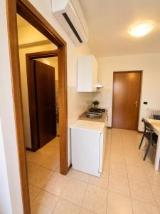 a kitchen with a sink and a counter top at BeaMare - Monolocale - Massimo tre ospiti con posto spiaggia - Studio Apartment - Max 3 people with 1 private umbrella and two SunBeds at the private beach of Eraclea Mare in Eraclea Mare +3 photos