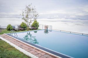 a swimming pool with a view of the clouds at Villa Labugolla in Kandy