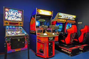 three arcade games are lined up next to each other at ibis budget Amsterdam City South in Amstelveen