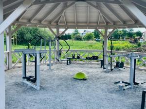 a group of benches and a gym with weights at Sunset Resort Apartament Marco Marina in Grzybowo