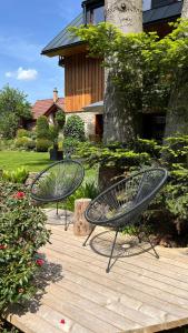 two metal benches sitting on a wooden deck at Pension Linda in Harrachov