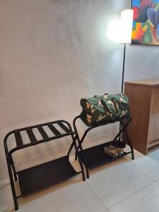 two beds in a room with a bag on them at Tropical Escape at Pico De Loro in Nasugbu