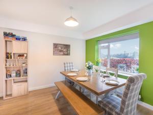 a dining room with a table and chairs and a window at Carr View Farm in Bamford