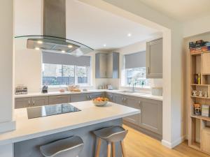 a kitchen with a island with a bowl of fruit on it at Carr View Farm in Bamford +22 photos