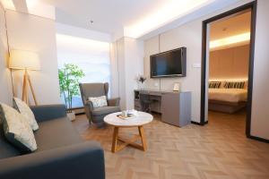 a living room with a couch and a table at HORIZON-boutique hotel in Chengdu