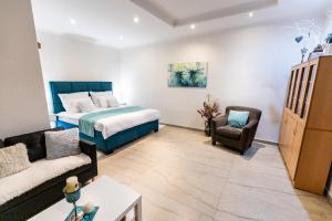 a bedroom with a bed and a living room with a couch at Apartman Karlina 100 m2 Terrace Garden in Šahy