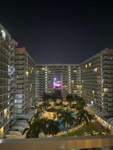 a view of two large buildings at night at Shell Staycation in Manila