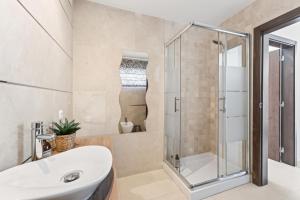a bathroom with a sink and a shower at Paradise Villa Cabanita Loulé in Loulé