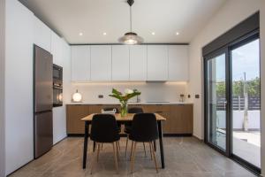 a kitchen with a wooden table and chairs at Casadi Fileri Villa in Ialysos