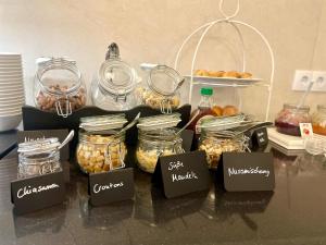 a table with many jars of food on it at Hotel Salina B&B - mit Parkplatz, Zentral und Digital in Bad Rothenfelde +22 photos