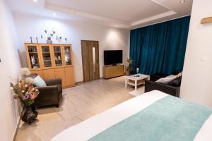 a hotel room with a bed and a living room at Apartman Karlina 100 m2 Terrace Garden in Šahy