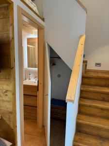 a staircase leading to a bathroom with a sink at Ca' del Maglio in Cison di Valmarino +32 photos