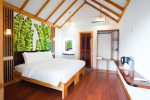 a bedroom with a white bed and a large window at Black Pearl View in Himandhoo 