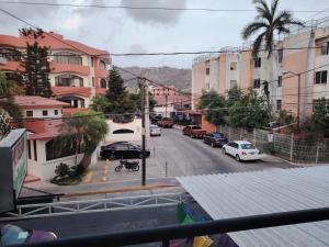 a view of a city street with cars and buildings at Depas las Palmas in Zihuatanejo