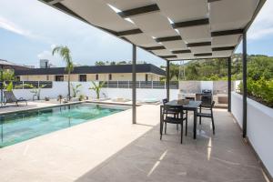 a patio with a table and chairs next to a swimming pool at Casadi Fileri Villa in Ialysos