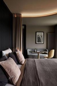 a bedroom with a bed and a table in a room at Navy black in Chom Bung