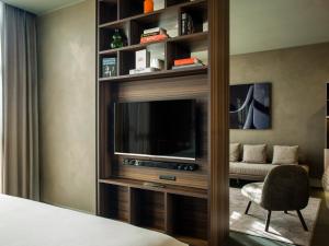 a living room with a television and a couch at ME by Meliá Milan Il Duca in Milan