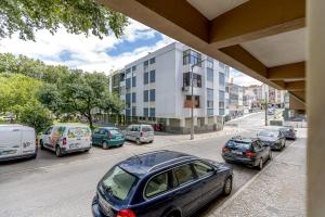 a group of cars parked on a city street at Seixal River Retreat in Amora