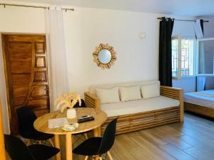 a living room with a couch and a table at Odyssée Résidence in Mahajanga +37 photos