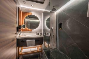 a bathroom with a sink and a shower at CITY ASYA HOTEL in Bandırma
