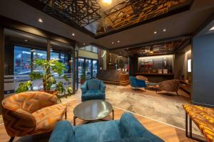 a lobby with blue couches and chairs at CITY ASYA HOTEL in Bandırma