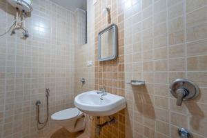 a bathroom with a sink and a toilet at Old Goa Residency in Old Goa