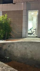 a window of a building with a chair in it at Fenomenall Kitnet in Campina Grande