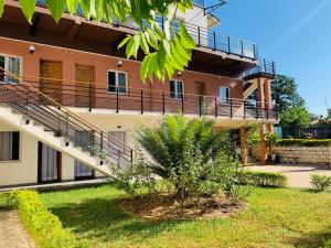a house with a staircase in front of it at Odyssée Résidence in Mahajanga