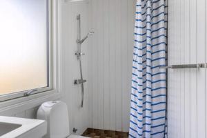 a bathroom with a shower with a toilet and a sink at Simple Summer Living In Magical Setting in Nykøbing Sjælland