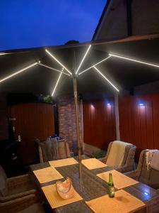 a table with an umbrella with lights on it at Magic of Mullingar in Mullingar